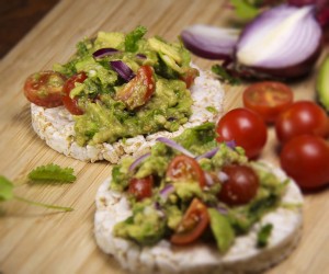 Delicious guacamole on rice cakes. A perfect healthy snack.
